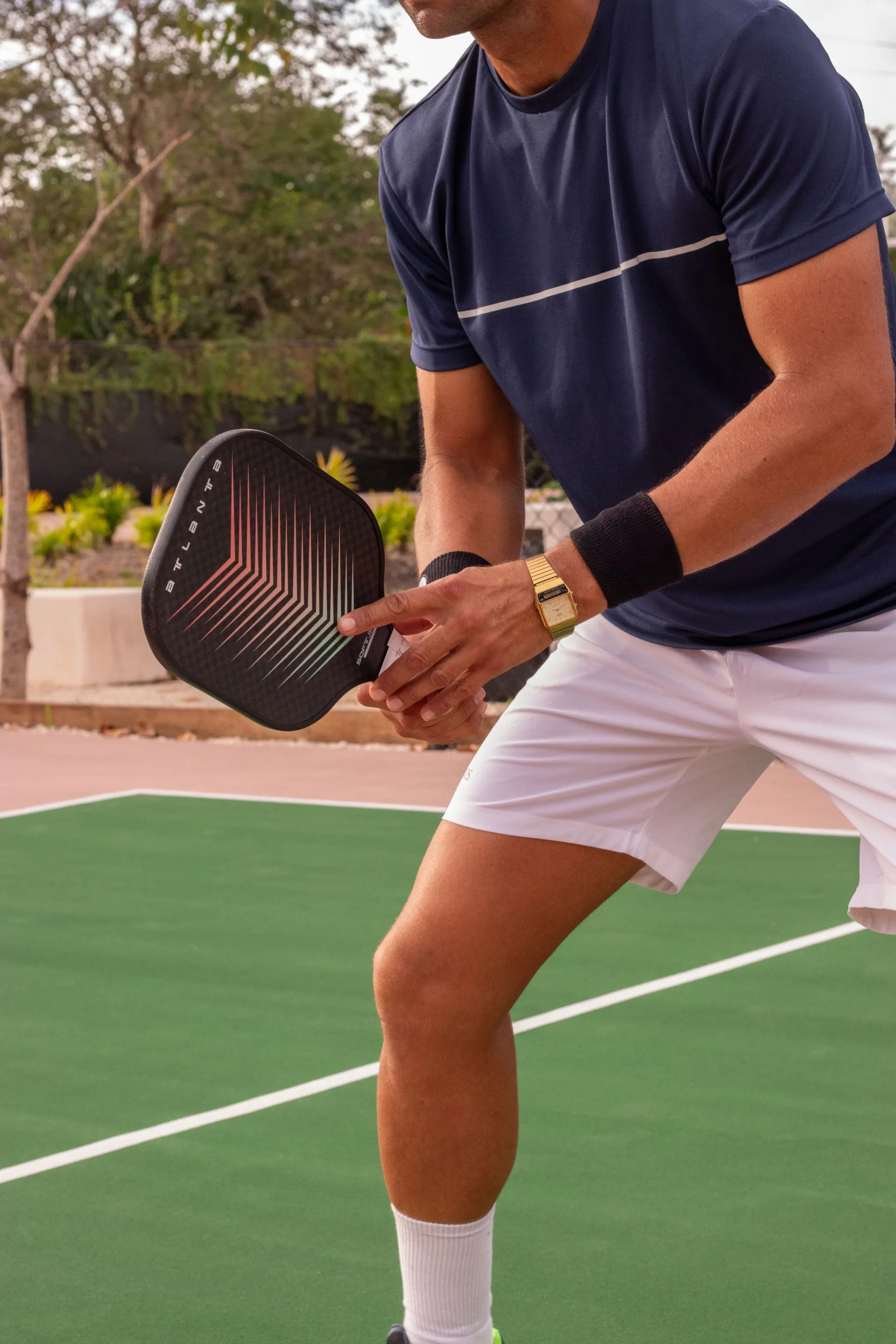 Player ready at the baseline with paddle in hand