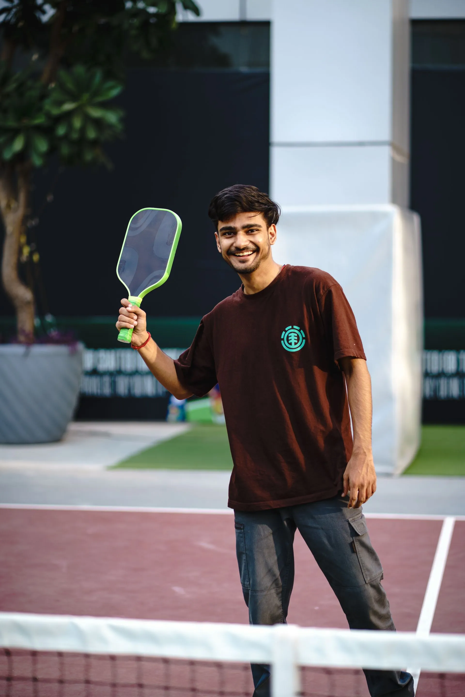 Smiling player holding up a paddle
